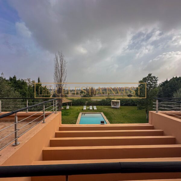 Zona exterior tranquila con piscina y jardín bien cuidado