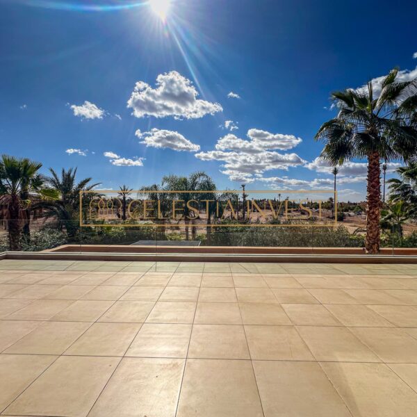 Large sun terrace overlooking palm trees in an exclusive location.