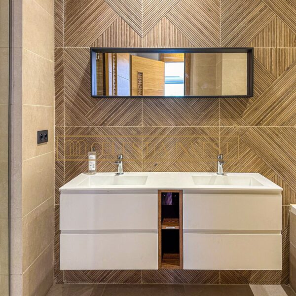 Designer bathroom with double washbasin and mirror