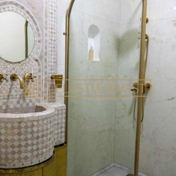 Elegant bathroom with mosaic shower and gold details