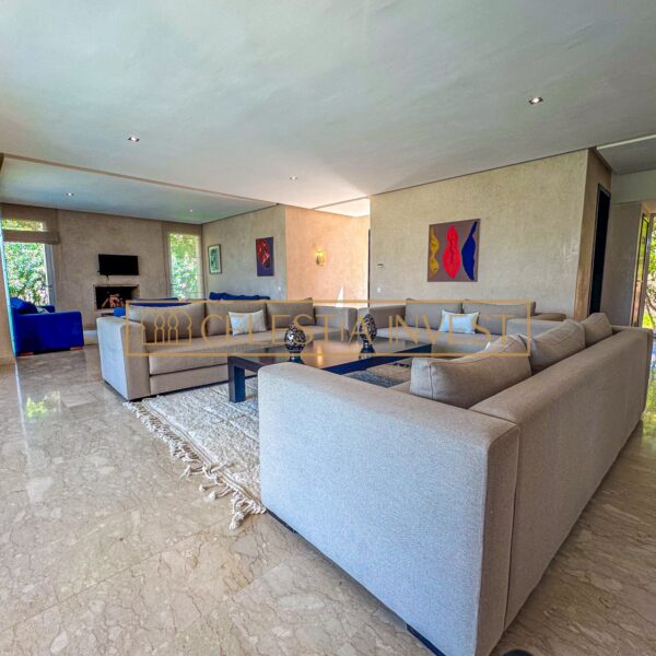 A warm and spacious living room with marble floor, fireplace and soft sofas, ideal for relaxing and entertaining guests.