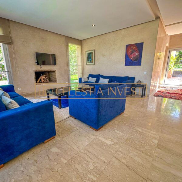 A warm and spacious living room with marble floor, fireplace and soft sofas, ideal for relaxing and entertaining guests.