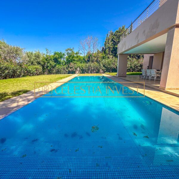 A sparkling pool surrounded by a lush patio and sun loungers, offering a refreshing oasis from the hot Moroccan sun.