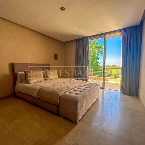 A serene, luxurious bedroom with king-size bed, dressing room and abundant natural light, offering a peaceful retreat.