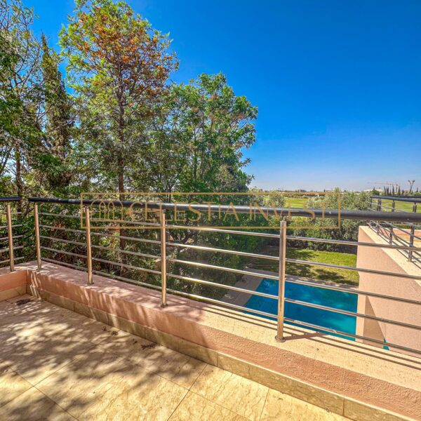 A sparkling pool surrounded by a lush patio and sun loungers, offering a refreshing oasis from the hot Moroccan sun.