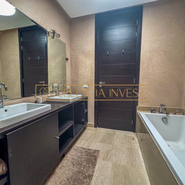 A spa-like bathroom with double sinks, bathtub and walk-in shower, offering a luxurious, revitalizing experience.