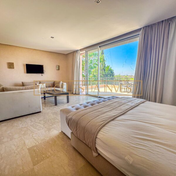 A serene, luxurious bedroom with king-size bed, dressing room and abundant natural light, offering a peaceful retreat.